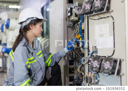 electricity engineer female working check service high voltage electrical cabinet. worker repair electric surge problem problem in industry factory. 101936352