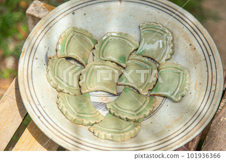 Sukhothai artisan art work of handmade clay pottery ancient style of Fish scales or Naga scales to decorate Asian temple. 101936366