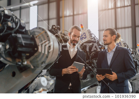 Businessman working in machinery factory robot assembly plant team working together Businessman working in machinery factory robot assembly plant team working together 101936390