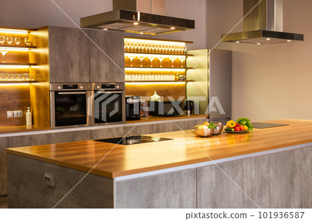 Modern minimalism style kitchen in new luxury home and cabinets and stainless steel appliances Modern minimalism style kitchen in new luxury home and cabinets and stainless steel appliances 101936587