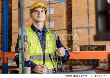 Caucasian male worker working in warehouse goods store. inventory staff moving producs pallet shipping management with folk lift truck. 101937343