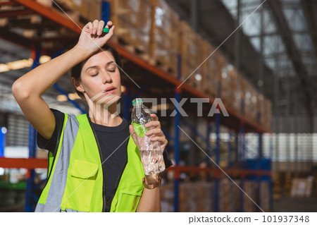 Tired stress woman staff worker sweat from hot weather in summer working in warehouse goods cargo shipping logistics industry. 101937348