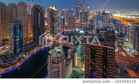 View of various skyscrapers in tallest recidential block in Dubai Marina aerial day to night timelapse 101939219