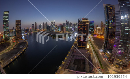Cityscape panorama of skyscrapers in Dubai Business Bay with water canal aerial day to night timelapse 101939254
