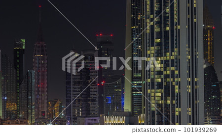 Row of the tall buildings around Sheikh Zayed Road and DIFC district aerial all night timelapse in Dubai 101939269
