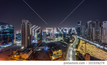 Water canal with modern towers residential development in Business Bay aerial panoramic all night timelapse, Dubai 101939274