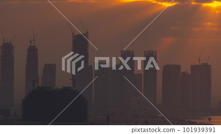 Sunrise over Dubai Creek Harbor with skyscrapers and towers under construction aerial timelapse Sunrise over Dubai Creek Harbor with skyscrapers and towers under construction aerial timelapse 101939391