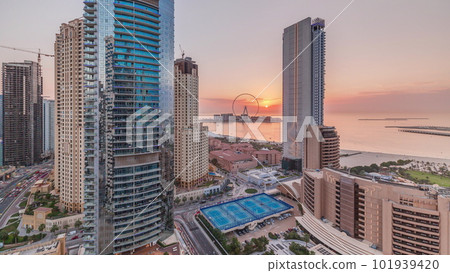 Panoramic sunset view of the Dubai Marina and JBR area and the famous Ferris Wheel aerial timelapse Panoramic sunset view of the Dubai Marina and JBR area and the famous Ferris Wheel aerial timelapse 101939420