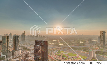 Sunrise over highway junction near media city and al barsha heights district area timelapse from Dubai marina. 101939549