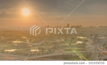 Sunrise over Golf course with green lawn and lakes, villa houses behind it timelapse. 101939550
