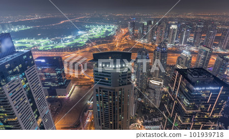 Panorama of Dubai Marina with JLT skyscrapers and golf course night timelapse, Dubai, United Arab Emirates. 101939718