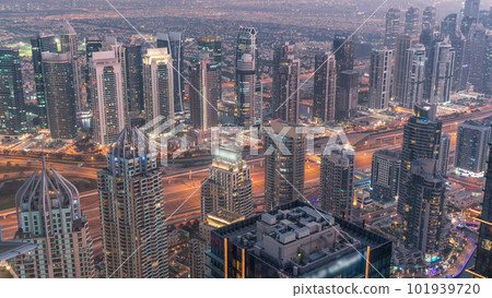 JLT and Dubai marina skyscrapers near Sheikh Zayed Road aerial day to night timelapse. Residential buildings 101939720