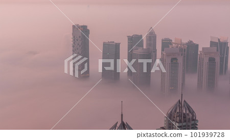 JLT skyscrapers near Sheikh Zayed Road aerial night to day timelapse. Residential buildings JLT skyscrapers near Sheikh Zayed Road aerial night to day timelapse. Residential buildings 101939728