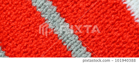 Handmade knitted fabric red and grey wool background texture Handmade knitted fabric red and grey wool background texture 101940388