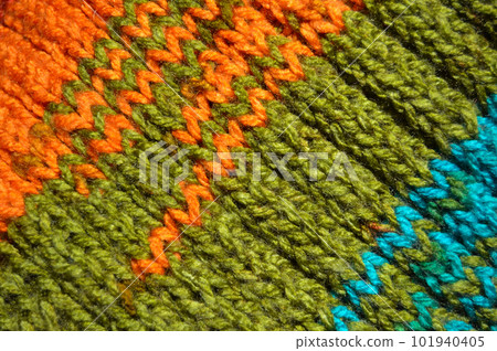 Handmade knitted fabric turquoise orange and green wool background texture Handmade knitted fabric turquoise orange and green wool background texture 101940405