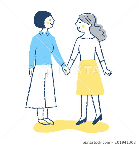 Two young women looking at each other and holding hands 101941308