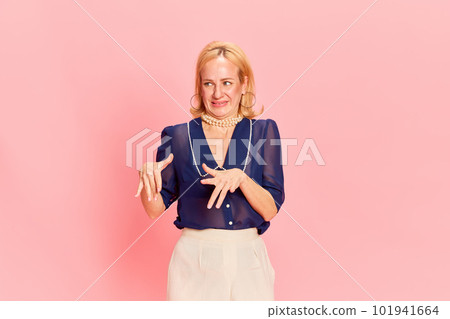 Portrait of adorable woman wearing elegant costume expressing disgusting with hands and looking away over pink background. Dislike 101941664