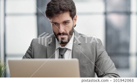 Successful businessman working inside office, man in business suit working at workplace with documents and laptop 101942068