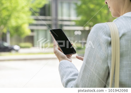 Hands of an Arafif business woman holding a smartphone 101942098