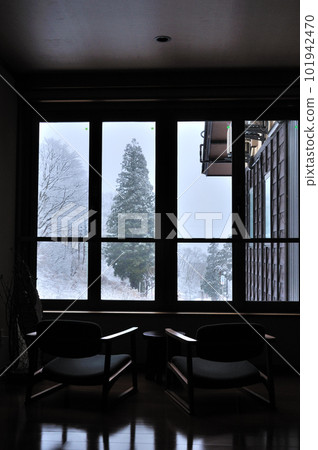 Snowy winter lodge window 101942470