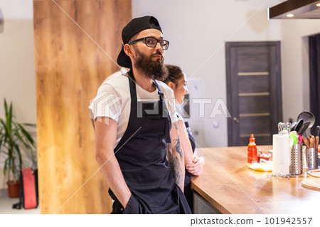 Happy confident young waiter entrepreneur looking at camera, smiling male small cafe business owner employee standing in restaurant, millennial businessman wear apron posing in coffee shop portrait Happy confident young waiter entrepreneur looking at camera, smiling male small cafe business owner employee standing in restaurant, millennial businessman wear apron posing in coffee shop portrait 101942557