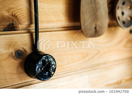 External electrical wiring in a wooden house. Safe Installation of electrical wiring inside a wooden house. Retro wiring in a wooden house 101942708