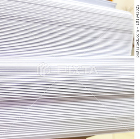 A stack of blank paper, book blocks prepared for binding in a printing house 101943025