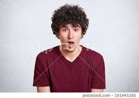 Close up portrait of shocked young man, expresses great surprisment. Astonished male, keeps mouth open, receives unexpected news, isolated on white background. Omg concept. Copy space for advertisment Close up portrait of shocked young man, expresses great surprisment. Astonished male, keeps mouth open, receives unexpected news, isolated on white background. Omg concept. Copy space for advertisment 101943288