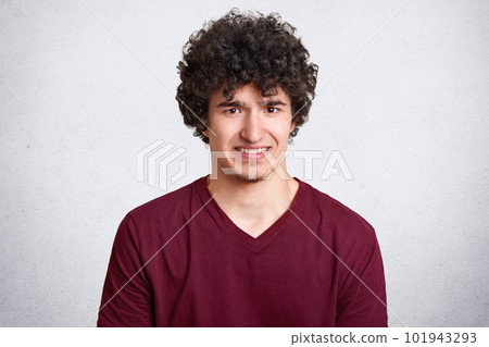 Attractive caucasian male with little beard and in glasses puts fingers in mouth showing disgust about new work with unpleasant people. Facial expression. Isolated over white background. Copy space. Attractive caucasian male with little beard and in glasses puts fingers in mouth showing disgust about new work with unpleasant people. Facial expression. Isolated over white background. Copy space. 101943293