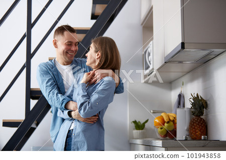 Happy young couple, man and woman spending time together at home, dancing in the morning in kitchen. Positivity 101943858