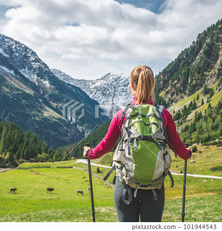 Young woman hiking in the mountains Young woman hiking in the mountains 101944543