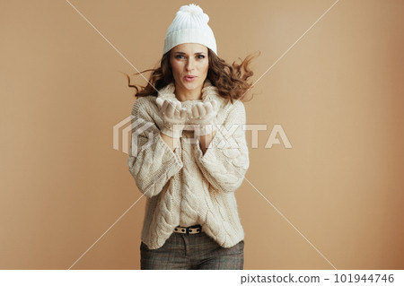 smiling stylish woman on beige background blowing snow smiling stylish woman on beige background blowing snow 101944746