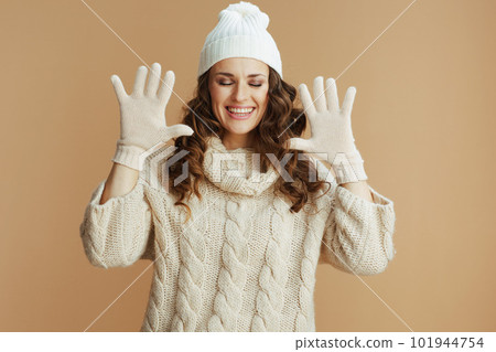 happy elegant woman against beige background happy elegant woman against beige background 101944754
