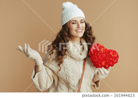 happy stylish woman against beige background with red heart happy stylish woman against beige background with red heart 101944823
