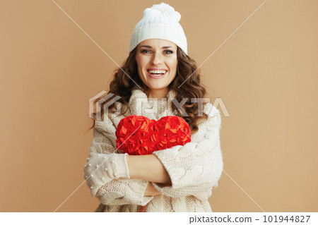 happy trendy female isolated on beige background with red heart happy trendy female isolated on beige background with red heart 101944827