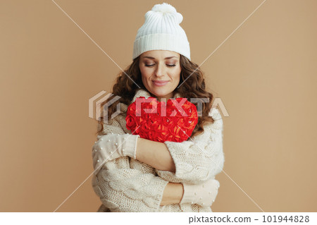 relaxed elegant woman on beige background with red heart relaxed elegant woman on beige background with red heart 101944828