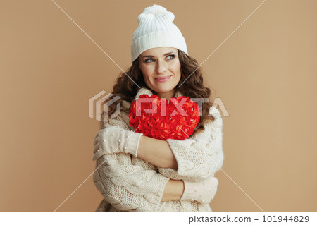 happy elegant woman against beige background with red heart happy elegant woman against beige background with red heart 101944829