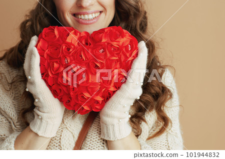 Happy woman in beige sweater, mittens and hat isolated on beige 101944832