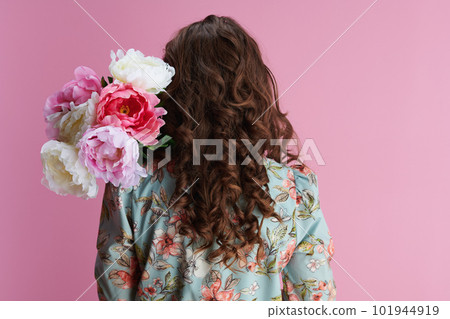 stylish woman with long wavy brunette hair on pink stylish woman with long wavy brunette hair on pink 101944919