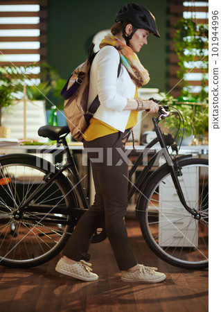 trendy business woman in bike helmet in modern eco office trendy business woman in bike helmet in modern eco office 101944996