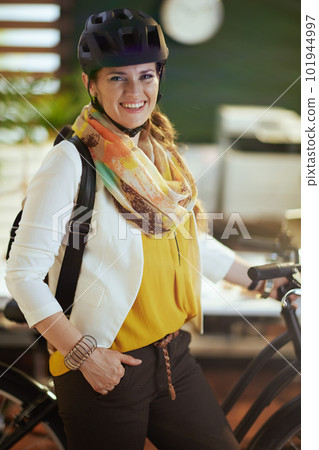Portrait of happy business woman in bike helmet in eco office Portrait of happy business woman in bike helmet in eco office 101944997