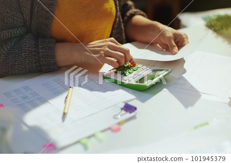 accountant woman with calculator and documents working 101945379