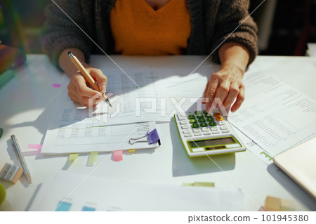 accountant woman with calculator and documents working 101945380