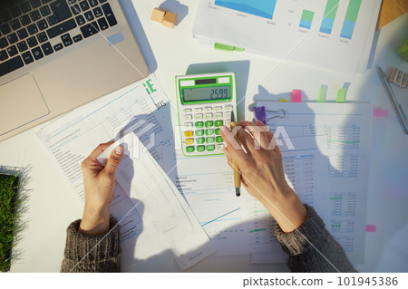 accountant woman with calculator and documents working 101945386