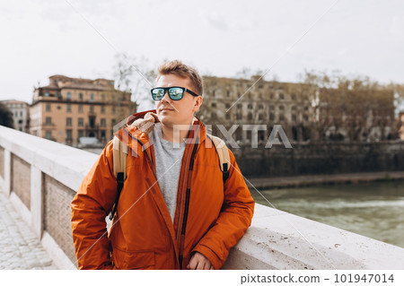 Happy young man walking on city street, Urban lifestyle concept. Traveler Happy young man walking on city street, Urban lifestyle concept. Traveler 101947014