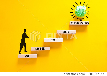 We listen to our customers symbol. Concept words We listen to our customers on wooden block. Beautiful yellow background. Businessman icon. Business we listen to our customers concept. Copy space. We listen to our customers symbol. Concept words We listen to our customers on wooden block. Beautiful yellow background. Businessman icon. Business we listen to our customers concept. Copy space. 101947194