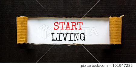 Start living symbol. Concept words Start living on beautiful white paper. Beautiful black paper cardboard background. Business and Start living concept. Copy space. 101947222