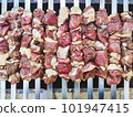 Appetizing shashlik skewers with raw lamb on grill, top view 101947415