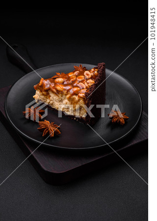 Delicious fresh cheesecake cake or snickers with cream and nuts Delicious fresh cheesecake cake or snickers with cream and nuts 101948415