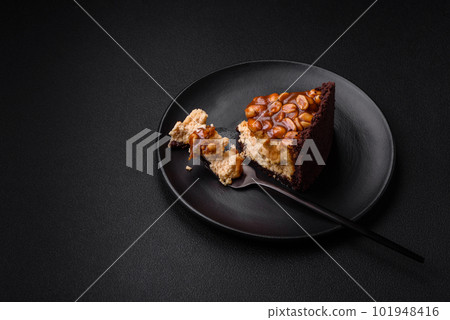 Delicious fresh cheesecake cake or snickers with cream and nuts 101948416